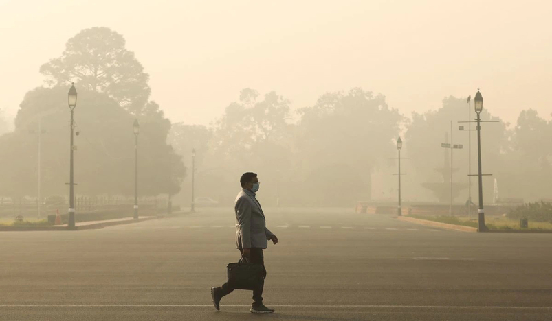 A man walk amidst air pollution in India
